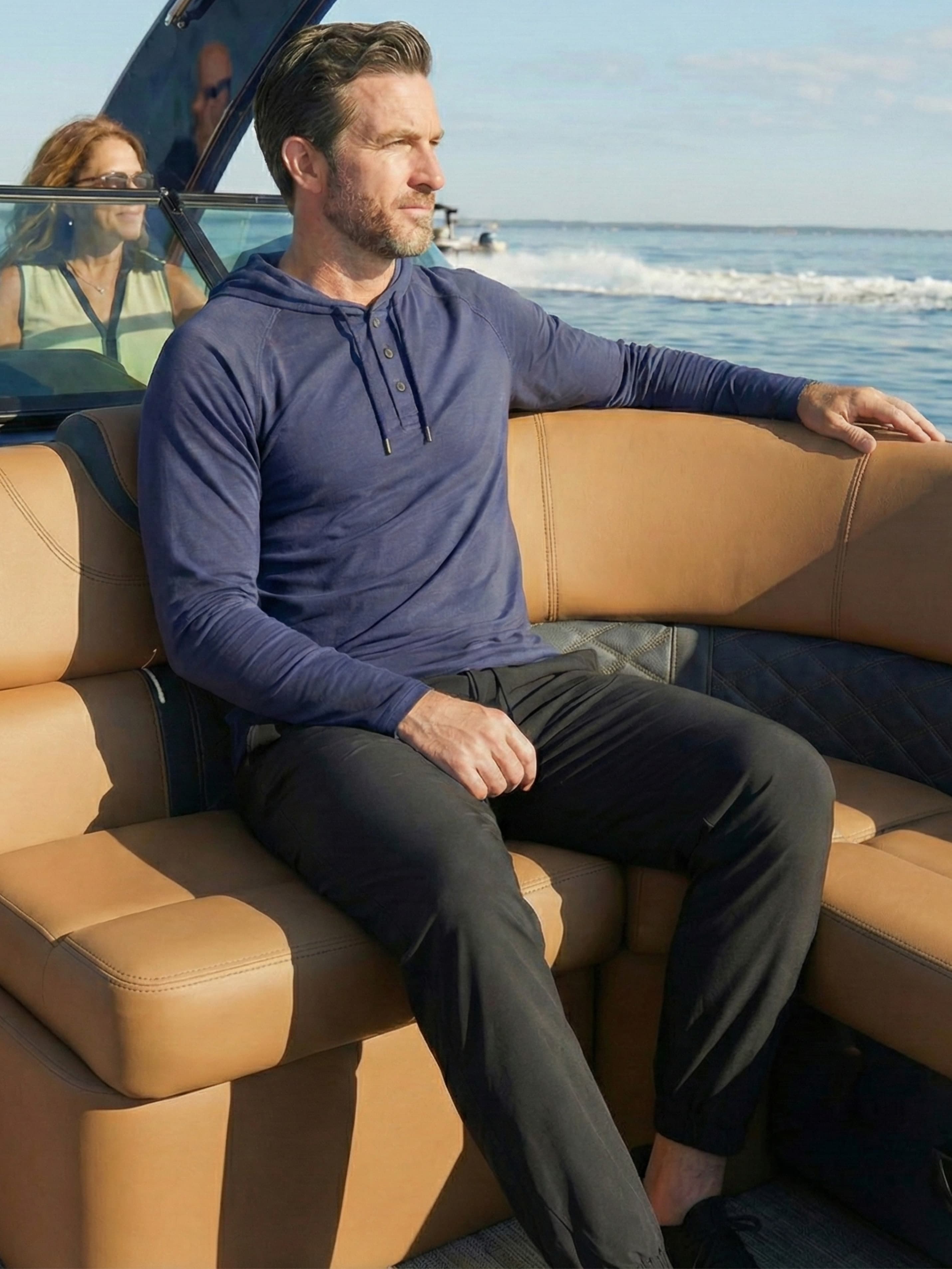 Man in midnight joggers on boat